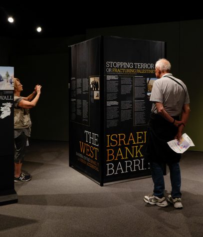 A few visitors at the Arizona State Museum enjoying the information and images provided at the new exhibition, "The History of Walls; The Boarders We Build".