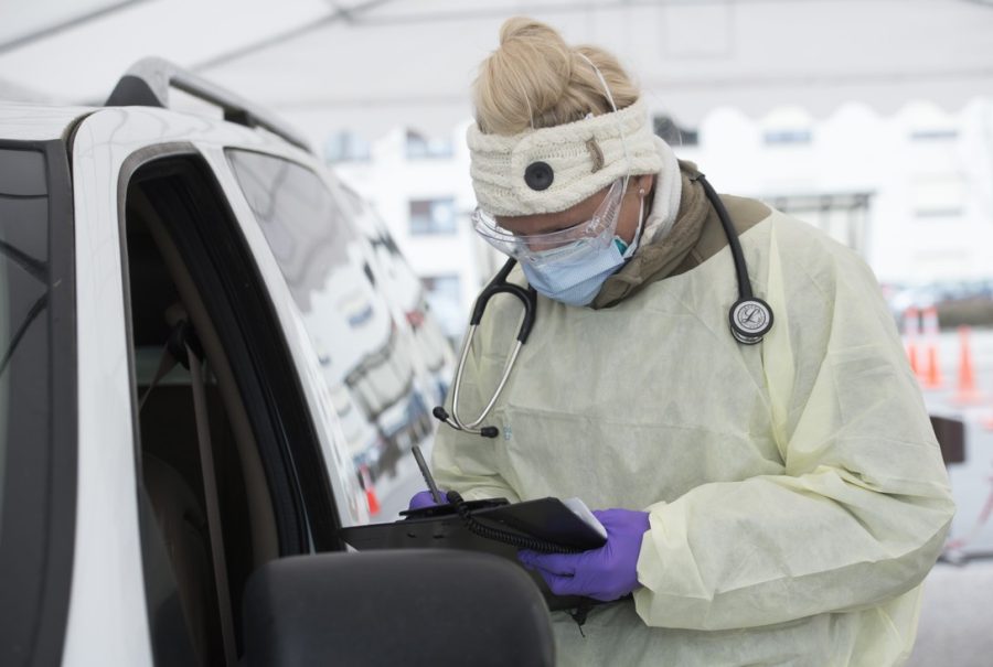 U.S. Air Force Staff Sgt. Maxime Copley, 86th Medical Group independent duty medical technician, writes down patient information in the Ramstein Medical Clinic’s coronavirus disease 2019 screening drive-thru at Ramstein Air Base, Germany, March 31, 2020. The 86th MDG transformed their main parking lot into a drive-thru to expedite testing and prevent the spread of COVID-19. (U.S. Air Force photo by Airman 1st Class Taylor D. Slater)