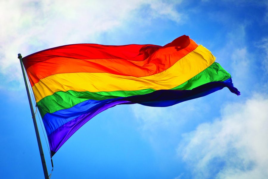 An+LGBTQ%2B+Pride+flag+flowing+in+the+wind.