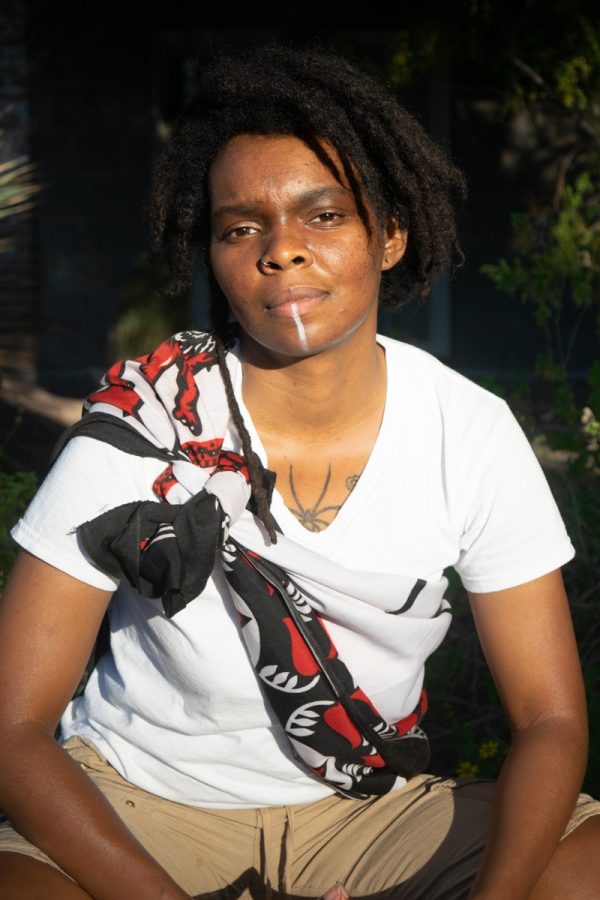 Artist Tyrell Blacquemoss sits in the Tucson sun. 