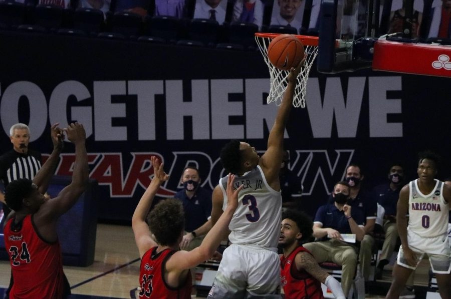 Jemarl Baker Jr. drives the hoop and makes a layup over an Eastern Washington defender at the McKale Memorial Center, Saturday Dec 5, 2020. 