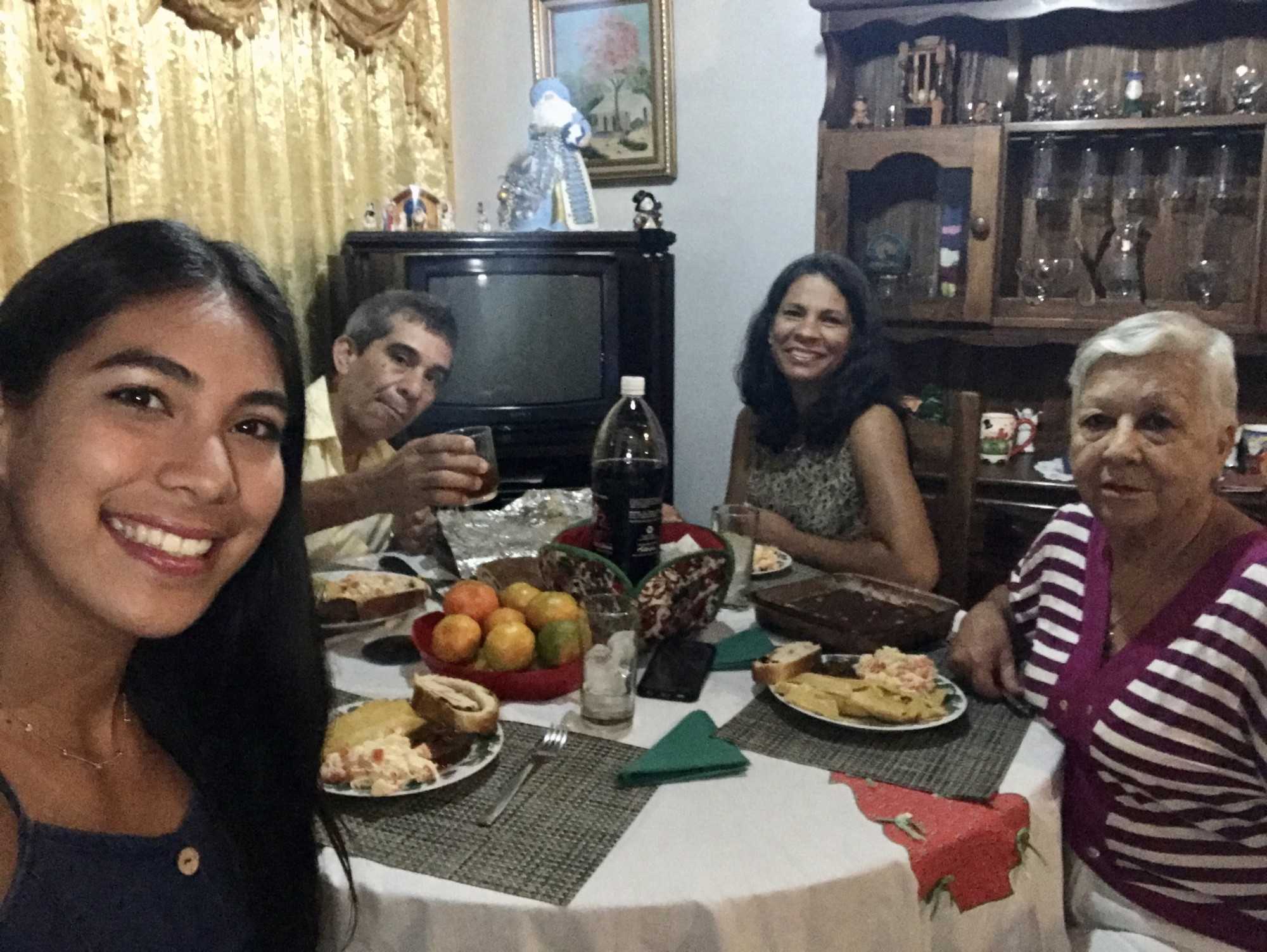 From right to left to right Diana Ramos, Douglas Ramos, Oneyda Ramos and Dilia Ramos eat dinner on Dec. 24, 2019 at the Ramos' house in Guatire, Venezuela. In Venezuela the traditional Christmas food is hallaca, round roast, chicken salad and ham bread. 