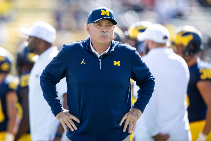 Former Michigan football defensive coordinator and current Arizona football defensive coordinator Don Brown stands on the sideline and looks out to the field with his hands on his hips in Ann Arbor, Michigan. (Courtesy of University of Michigan Athletics.) 