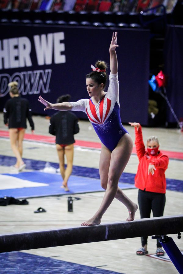 Caroline Herry performs a routine on the balance beam. Herry earned a score of 9.900 for the routine in McKale Center on Saturday, March 13, 2021.