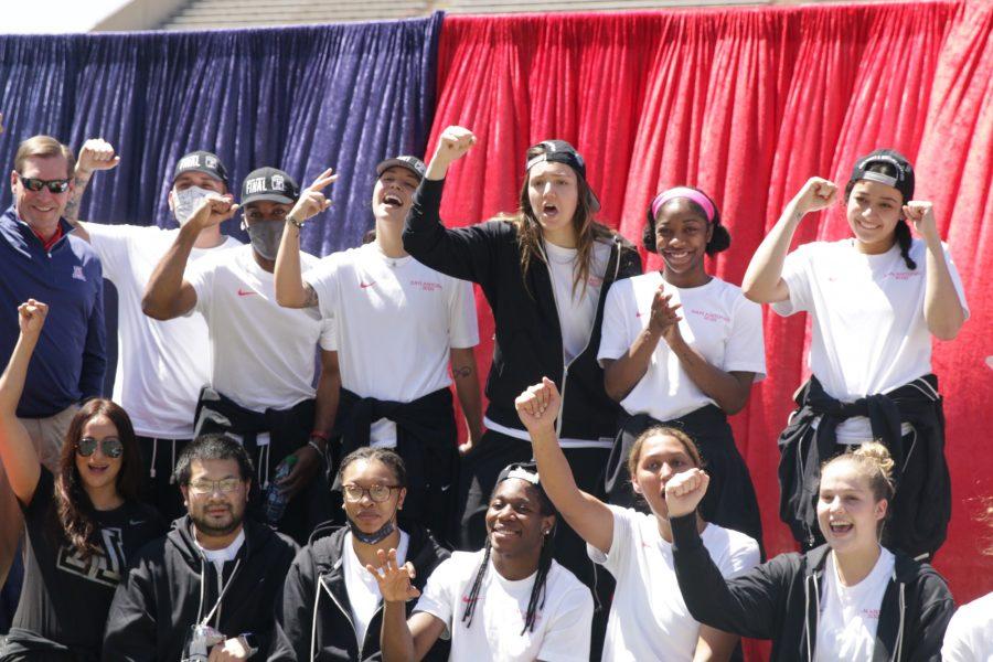 Women’s basketball staff and team members cheer and chant at a “welcome home” rally on Monday, Apr. 5 in Tucson, Ariz. The Wildcats made history by competing in the NCAA championship the previous weekend.