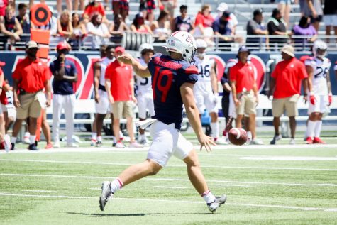 Kyle Ostendorp kicks the ball in the Spring Game on Saturday, April 24 in Tucson, Ariz. Gronkowski and Bruschi served as coaches for the Spring Game.