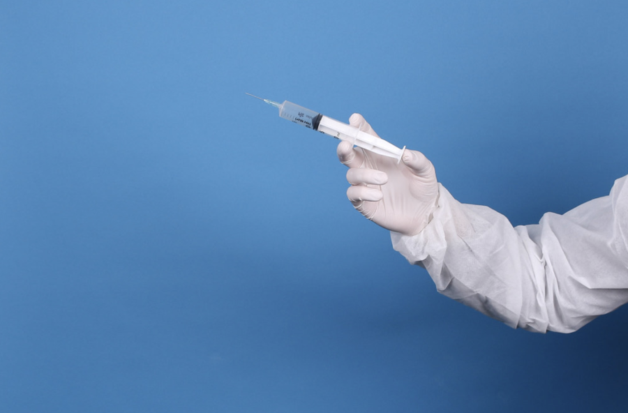 This week, Pfizer/BioNTech reported that its coronavirus vaccine is 100% effective in children ages 12 to 15. Some experts warn of a possible resurgence of cases across the country. Doctor in protective suit and face mask holding syringe by focusonmore.com is licensed with CC BY 2.0.
