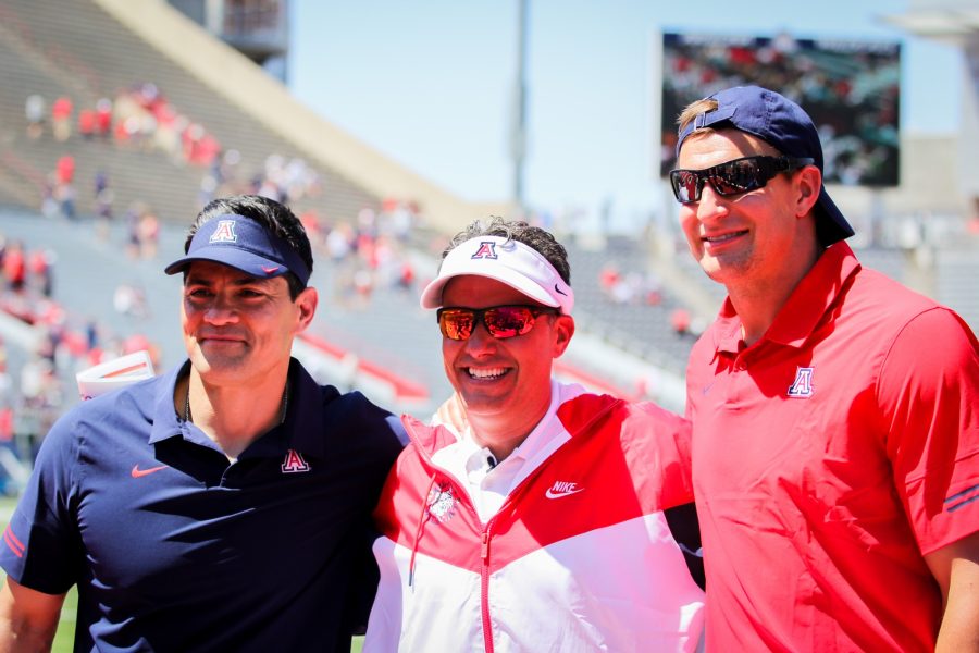 Tedy Bruschi (left), Jedd Fisch (center) and Rob Gronkowski (right) celebrate a successful Spring Game. Gronkowski and Bruschi served as coaches on Saturday, April 24 in Tucson, Ariz.
