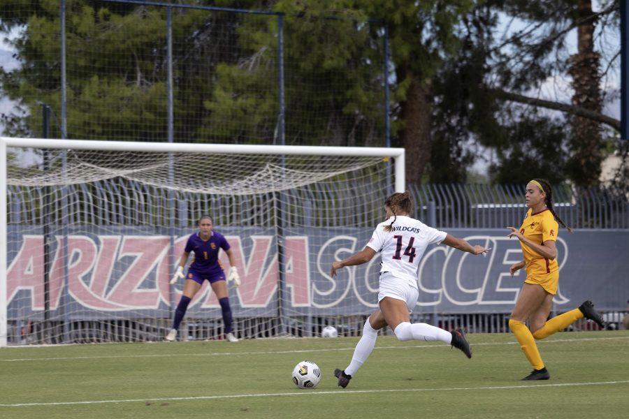 Jill Aguilera (14) kicks the ball towards the goal during the game against the University of Southern California on Murphey Field at Mulcahy Soccer Stadium on Oct. 3. The final score was a 4-1 loss for the Wildcats.