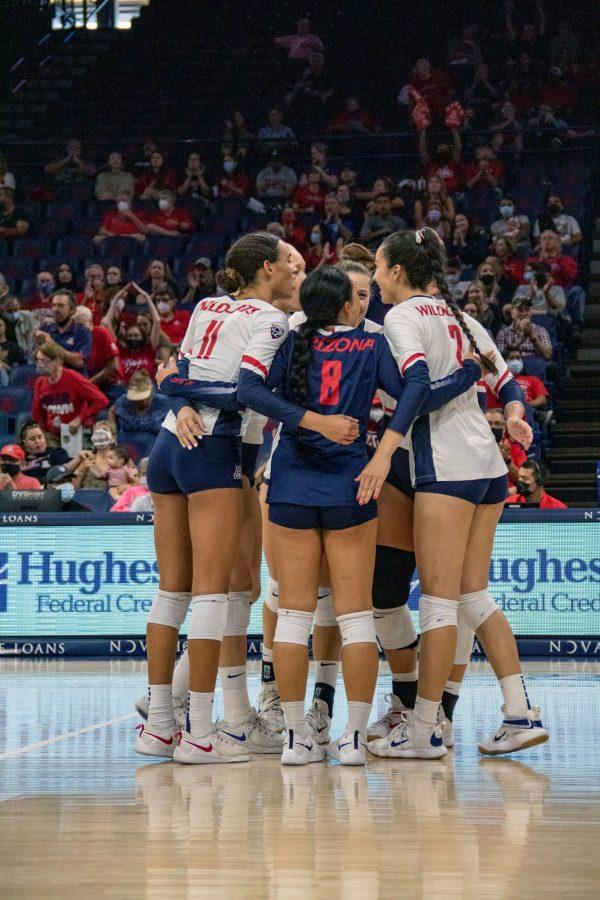 Players on Arizonas volleyball team huddle up to celebrate securing a point during the game against the University of Southern California on Oct. 17, in McKale Center. With a final score of 3-1, Arizona lost to USC.