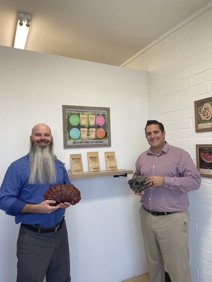 Business partners Cody Lewallen (left) and Basilio Avila (right) pose with mushrooms.