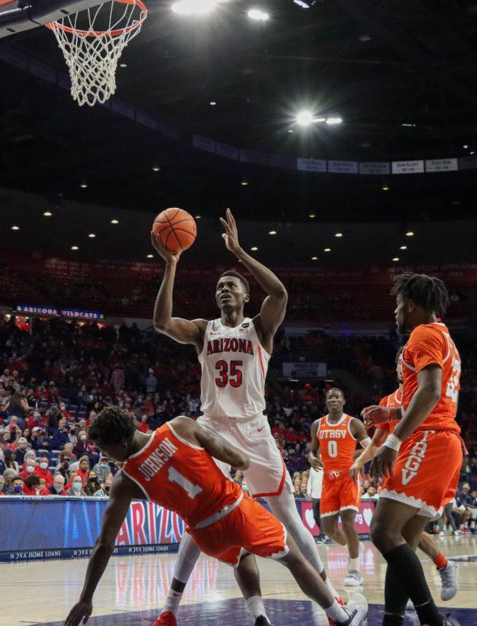 Christian Koloko, a sophomore on the Arizona mens basketball team, looks to take a layup after colliding with a Texas-Rio Grande Valley Vaqueros defender on Friday, Nov. 12, in McKale Center. The Wildcats lead at half 49-24.