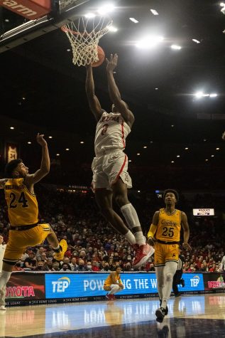 Arizona men's basketball player Bennedict Mathurin dunks a basketball at the game against Wyoming on Dec. 8 in McKale Center. Mathurin finished the game scoring the a total of 24 points.