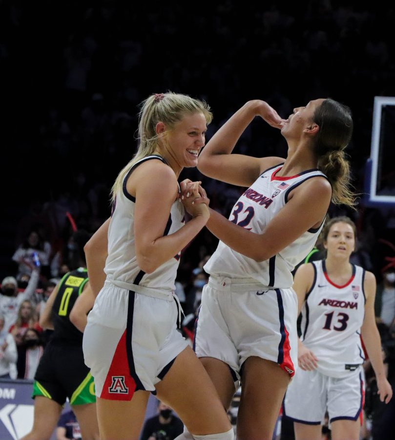 Teammates Cate Reese and Lauren Ware laugh after a half-court shot that ended the third quarter on Friday, Feb. 4 in McKale Center. The University of Arizona would win the game 63-48.