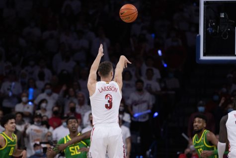 Pelle Larsson a guard on the Arizona men's basketball team shoots a three point shot on Saturday Feb. 19 in the McKale Center. The WildCats would win in the final seconds 84-81.