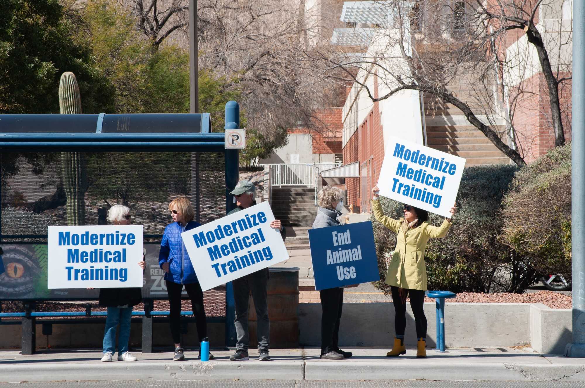 Protestors wave signs near the University of Arizona College of Medicine on Thursday, Feb. 24. Individuals were protesting against the use of live animals for medical studies at the UA. 