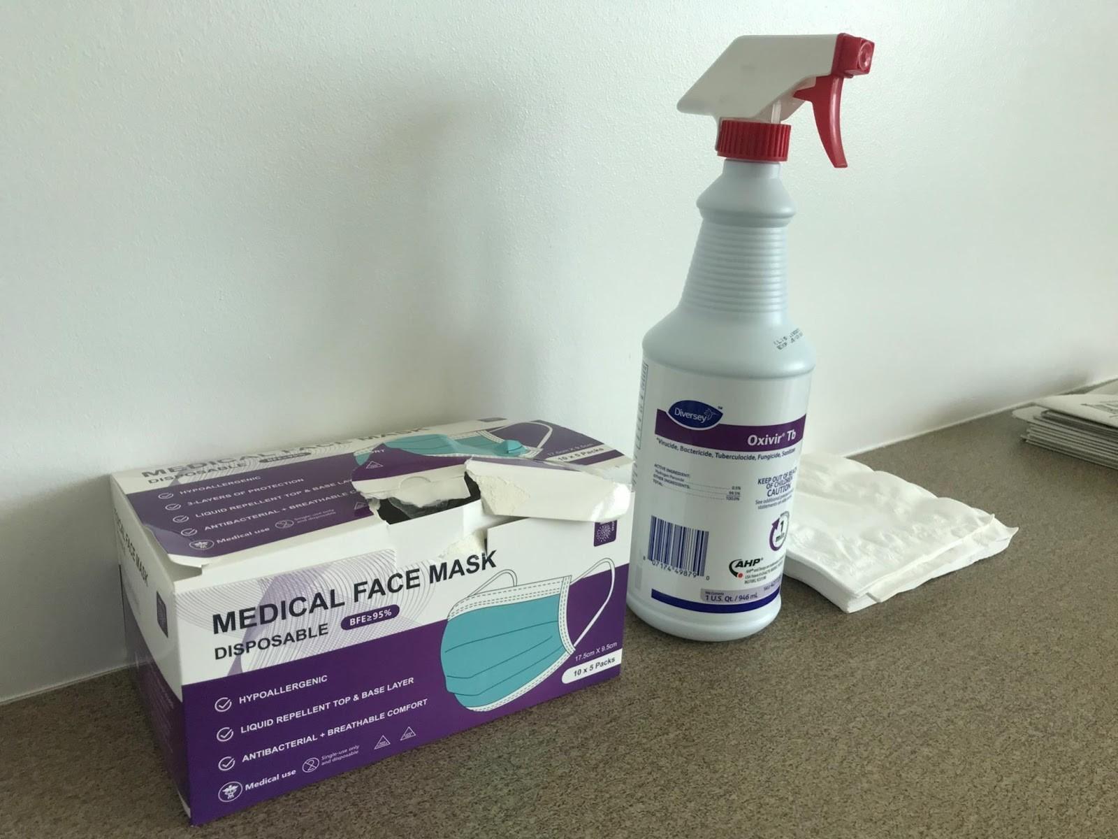 A box of disposable masks, disinfectant and napkins on a table in the Undergraduate Lounge at the University of Arizona's Marshall building.