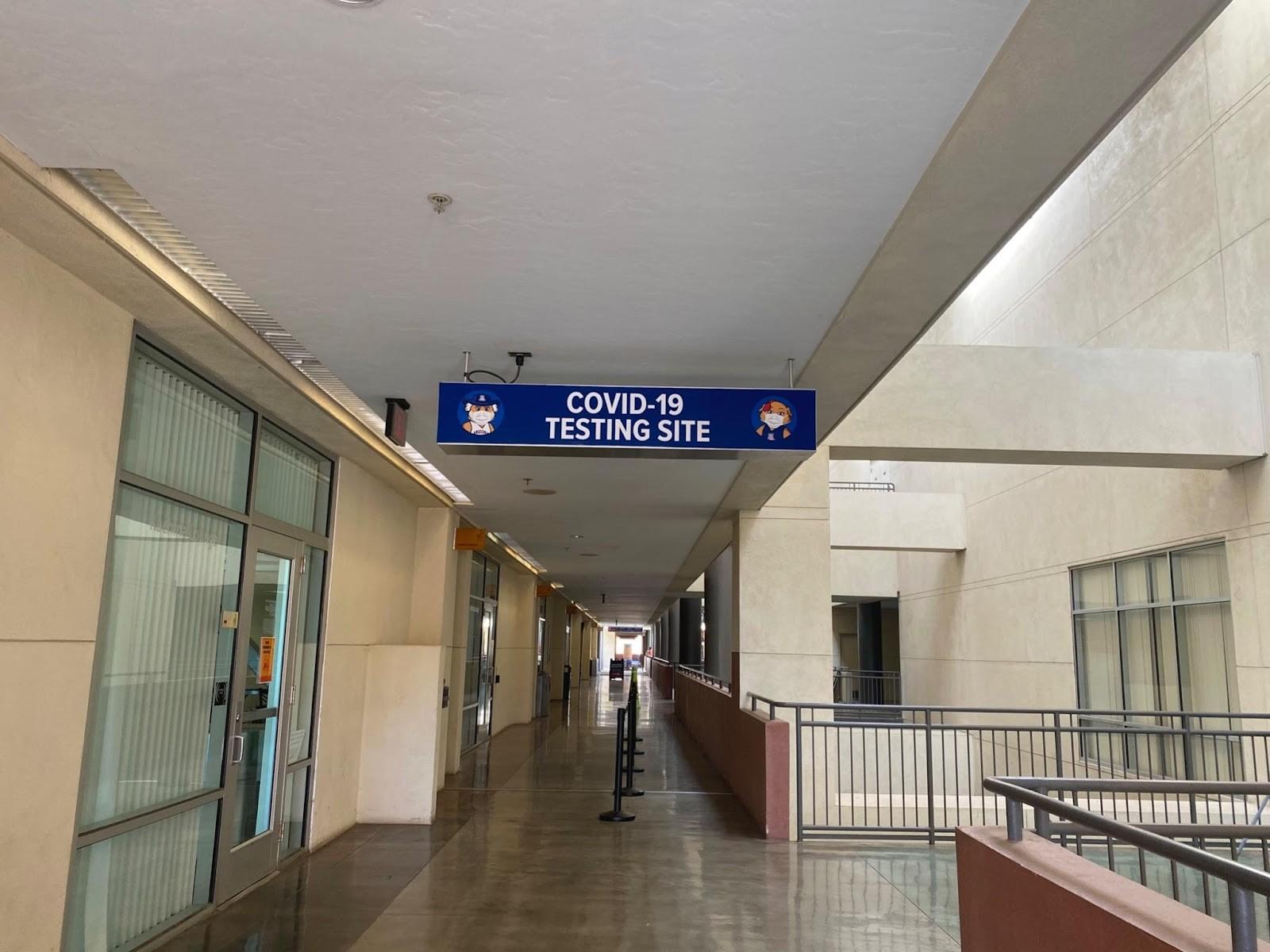 A COVID-19 testing site sign hangs in a Student Union Memorial Center hallway. (Courtesy Genavieve Sinner)