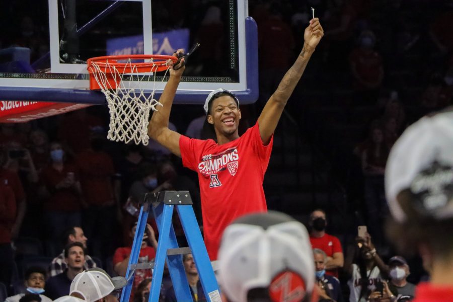 Dalen Terry, a player on the Arizona mens basketball team cuts down his part of the net after the game on Saturday, March 5 in McKale Center. The Wildcats are ranked second in the nation for mens basketball.