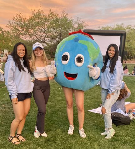 Students for Sustainability co-directors Marissa Lee, Jeri Wilcox and Chelsea Mendoza pose with the organization's mascot at the screening of “WALL-E” on Monday night.