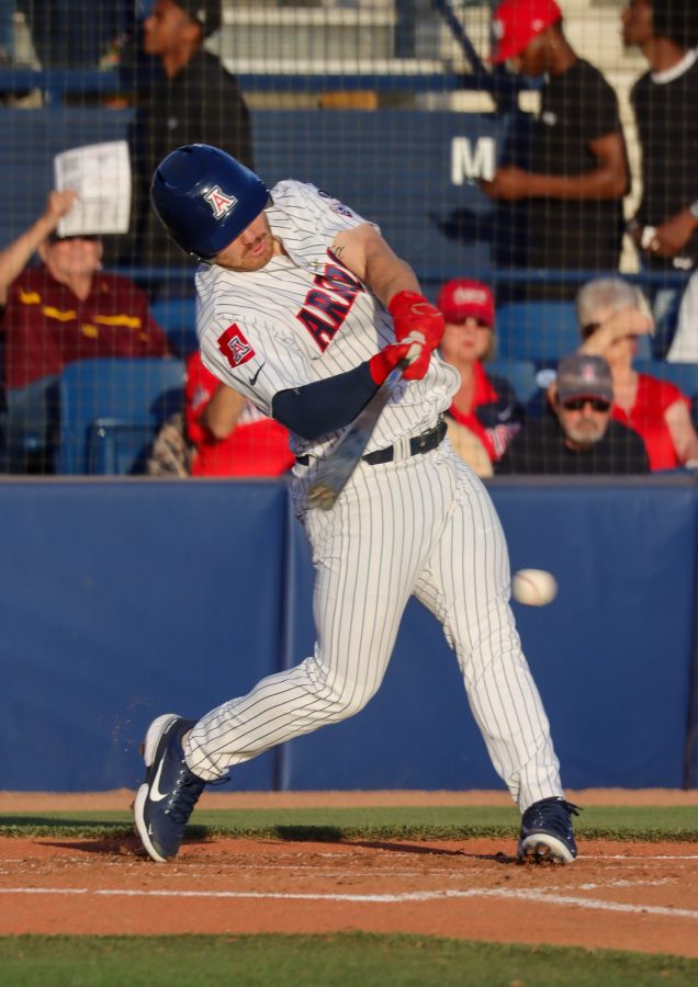 Tanner OTremba, an outfielder on the Arizona baseball team, hits a ball at his first at bat on April 22 at Hi Corbett field. The Wildcats would win in extra innings 7-6.