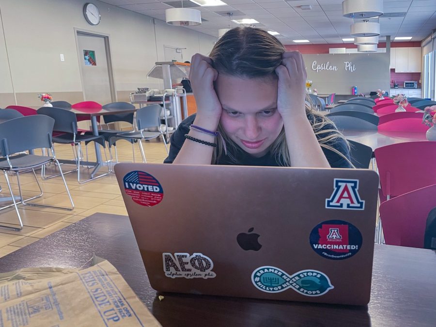 Photo Illustration: Student Alex Kramer stresses out over a homework assignment in Alpha Epsilon Phi chapter house. The pressure to push oneself can carry on throughout the summer. 