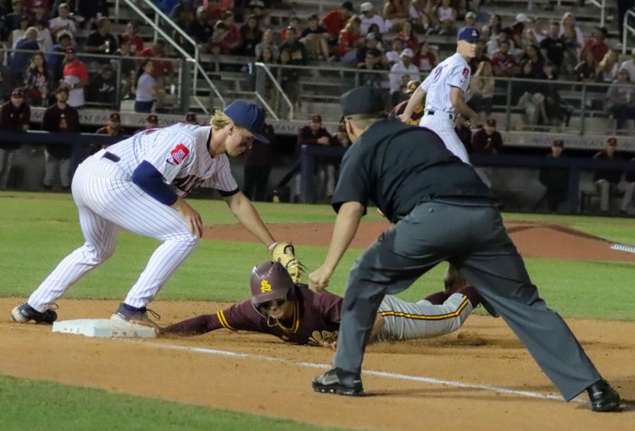 Noah Turley a first baseman on the Arizona baseball team tries to tag out a base runner on April 22 at Hi Corbett field. The Wildcats would win in extra innings 7-6.