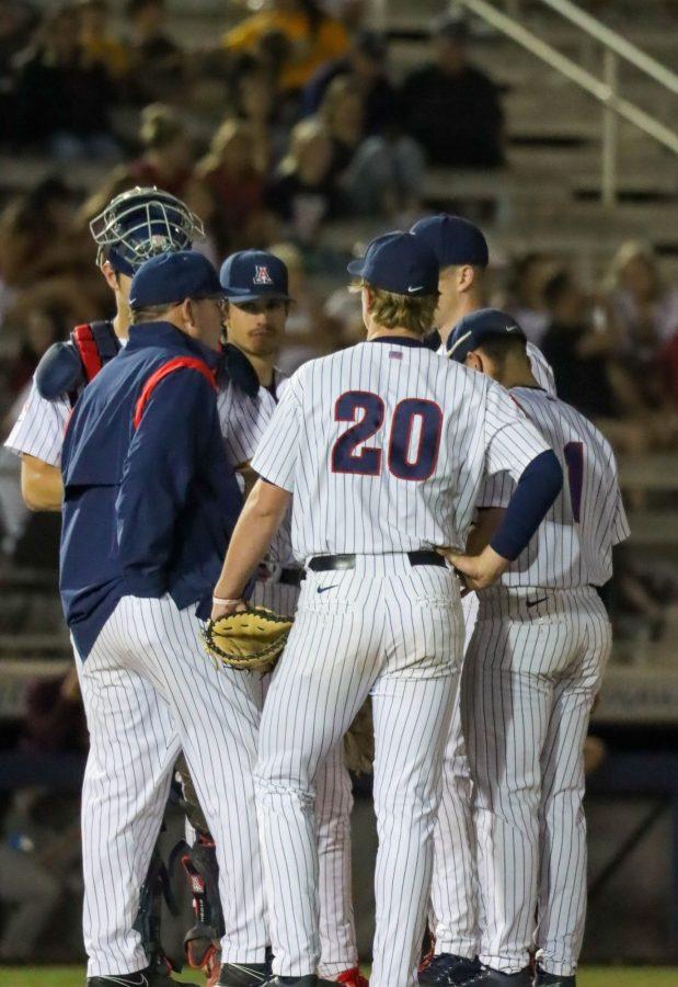 Coach Dave Lawn of the Arizona baseball team meets with the infield to help the team get out of the inning on April 22 at Hi Corbett Field. The Wildcats would win the game in extra innings 7-6.