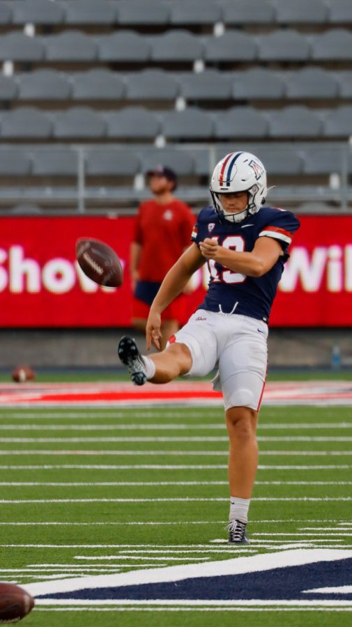 Kyle Ostendorp a punter on the Arizona football team practices punts during pregame on Saturday Aug. 20 at Arizona Stadium. The mock game would consist of the offence taking on the deffence for the night in a friendly scrimmage.
