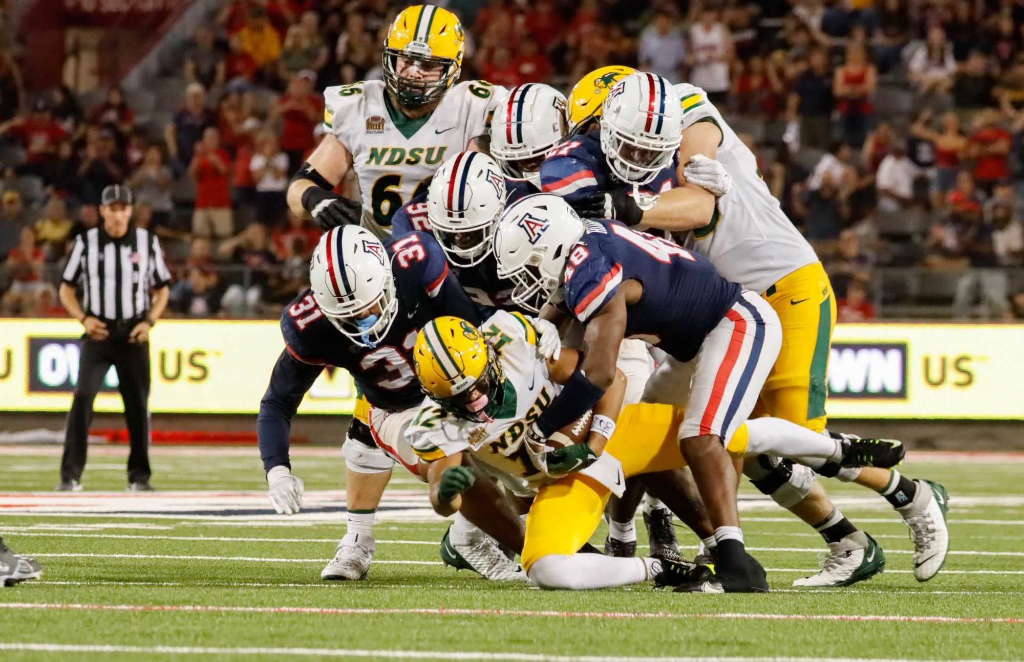 Arizona football defense makes a group tackle against a North Dakota State University running back on Saturday Sept. 17 in Arizona Stadium. The Wildcats would win 31-28 and advance their record to 2 and 1. 