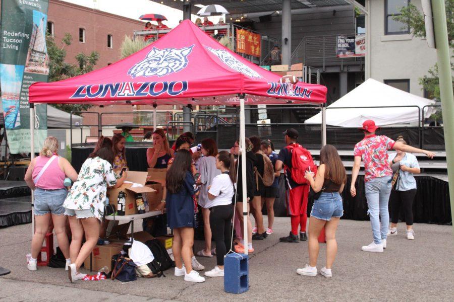 ZonaZoo organizers hand out T-shirts before Bear Down Friday to students with ZonaZoo passes on Sept. 9, 2022. Students are welcomed to grab a T-shirt and listen to music before the pep rally begins.