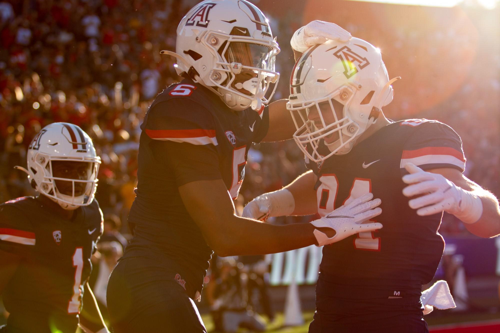 Dorian Singer (5) and Tanner McLachlan (84) celebrate a touchdown in a game against USC on Oct. 29 at Arizona Stadium. The Wildcats would go on to lose the game 37-45.
