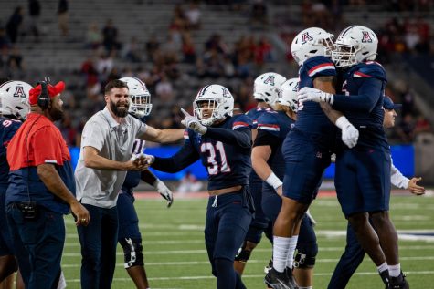 The Arizona football teams offensive line celebrates an interception at the game against the University of Colorado Boulder on Saturday, Oct. 1, at Arizona Stadium. The Wildcats would go on to win the game 43-20 and advance their record to 3-2.