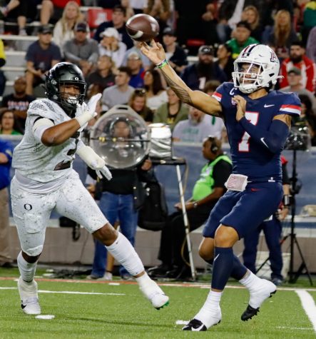Jayden De Laura quarterback on the Arizona football team throws a short pass on Oct. 8 in Arizona Stadium. The wildcats would loose the divisional game 49-22. 