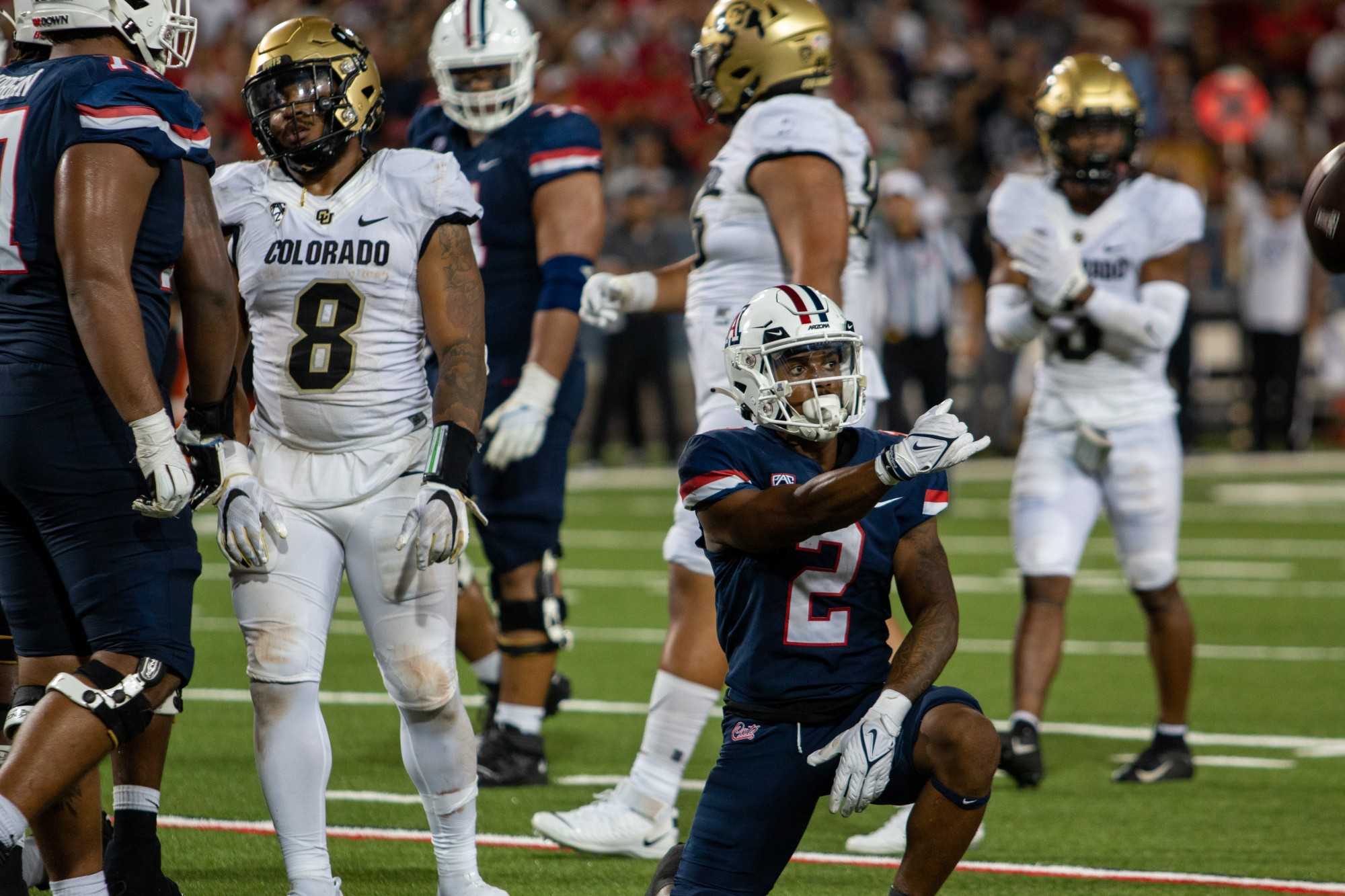 Jacob Cowing, a wide receiver on the Arizona football team, tosses the ball to a referee after a play at the game against the University of Colorado Boulder on Saturday, Oct. 1, at Arizona Stadium. The Wildcats would go on to win the game 43-20 and advance their record to 3-2.