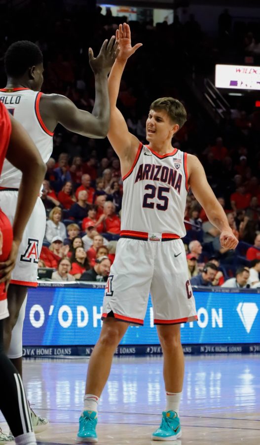 Kerrr+Krissa+%2825%29+a+point+guard+on+the+Arizona+mens+basketball+team+high+fives+a+teammate+after+scoring+a+point+on+Nov.+7%2C+in+McKale+Center.+The+wildcats+would+in+117-75.