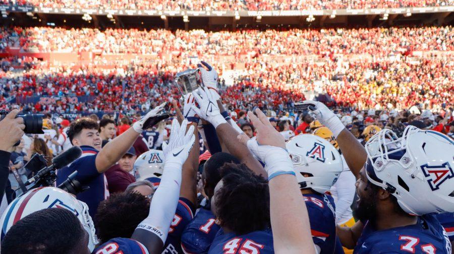 The+Arizona+football+team+holds+the+Territorial+Cup+after+winning+a+game+against+rival+Arizona+State+University+on+Nov.+25%2C+at+Arizona+Stadium.+The+Wildcats+won+38-35.