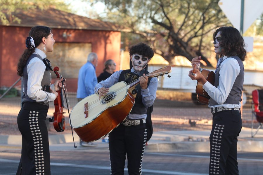 Three musicians play at the All Souls Procession on Nov. 6, on Grande Avenue. People crowd around the musicians to hear them play while dressed in face paint.
