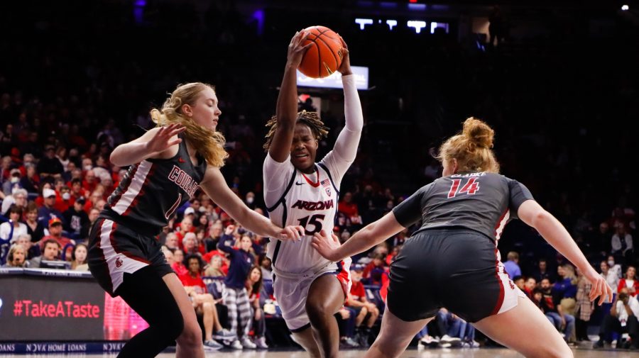Kailyn Gilbert a guard on the Arizona womens basketball team drives to the hoop through two defenders on Jan. 29 in McKale Center. The Wildcats would loose the divisional game against Washington State University 59-70.