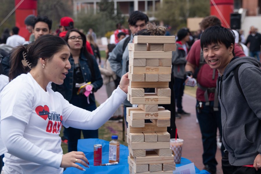 Slush Jacobs (left) and Bryan Wang (right) play a game of Giant Jenga on the UA Mall on Tuesday, Feb. 14. This was one of many games and activities on the Mall that raised money for the school through the Giving Day initiative. 