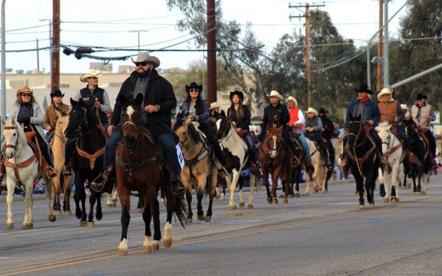 A large group of horseback-riding parade participants trots down the street during the annual Tucson Rodeo Parade on Feb. 23 at Ajo Highway, a half mile east of Park Avenue. The parade featured western-themed floats and buggies, historic horse-drawn coaches, festive Mexican folk dancers, marching bands and outfitted riders. 