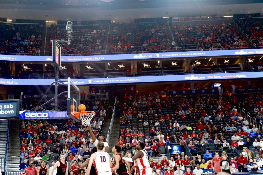 Arizona mens basketball forward Cedric Henderson Jr. scores a layup in a game against Stanford University on March 9 at T-Mobile arena. 