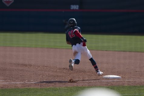 Arizona baseball player Kiko Romero runs to first base during the game against the University of California Berkeley on March 11 in Hi Corbett Field. The Arizona baseball team went on to win the game with a 7-5 score.