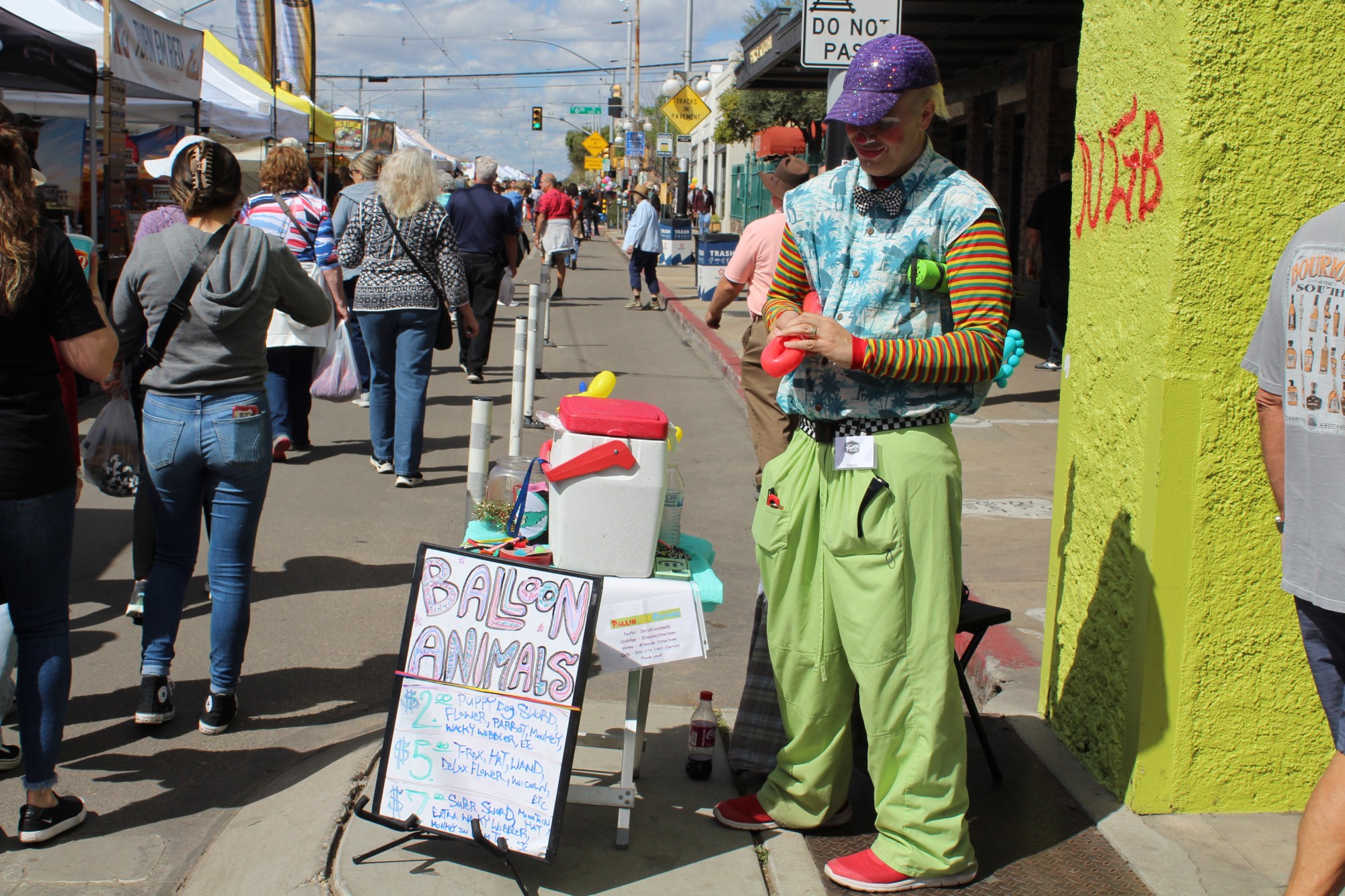 A man offers to make balloon animals at the Fourth Avenue Spring Street Fair on March 24. He was able to create puppies, t-rex, flowers and more. 