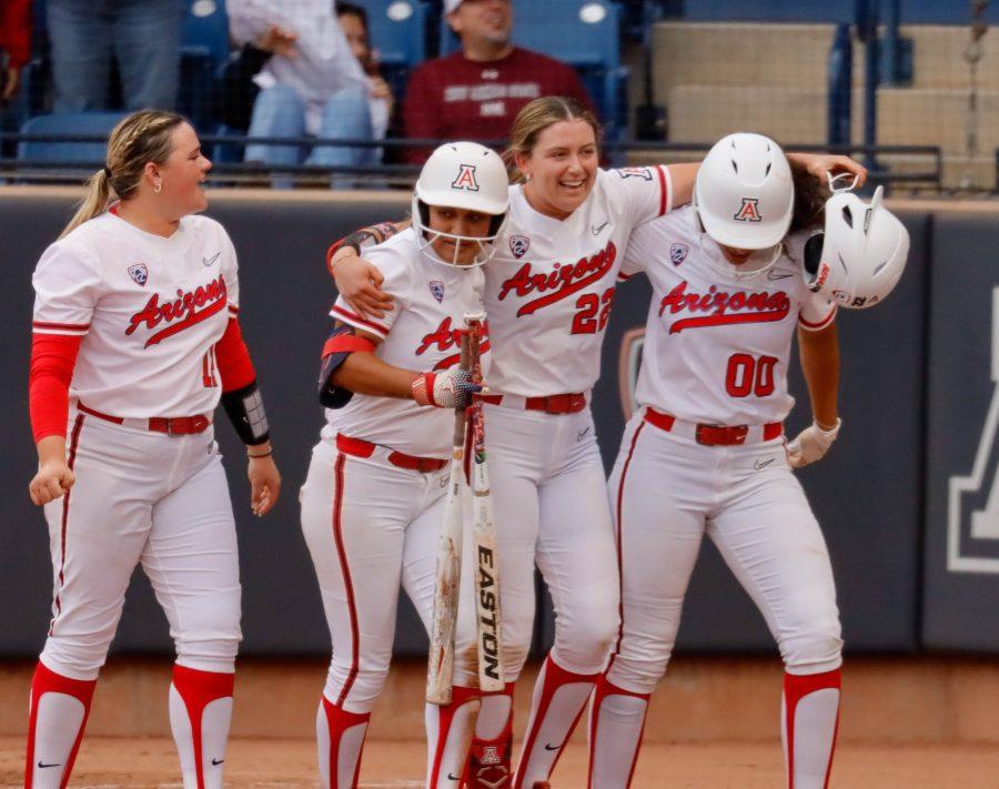 Arizona softball player Paige Dimler (22) celebrates with teammates after hitting her second home run of the season on March 15 in Rita Hillenbrand Memorial Stadium. Dimler helped the Wildcats win by hitting another home run to center field at her next at bat. 