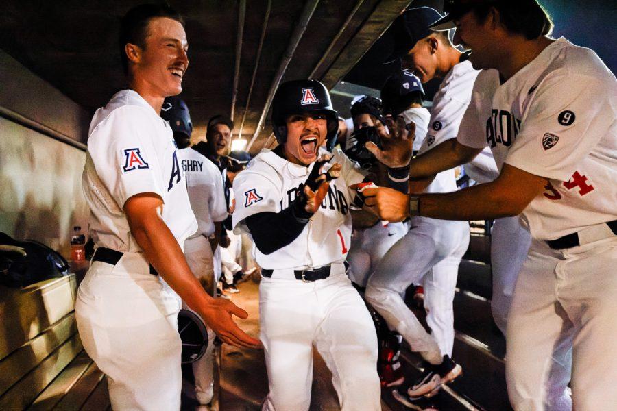 Arizonas Garen Caulfield celebrates in the dugout after hitting a home run during the game against California at Hi Corbett Field Friday, March 10. The final score was a 13-2 win for the Wildcats. 