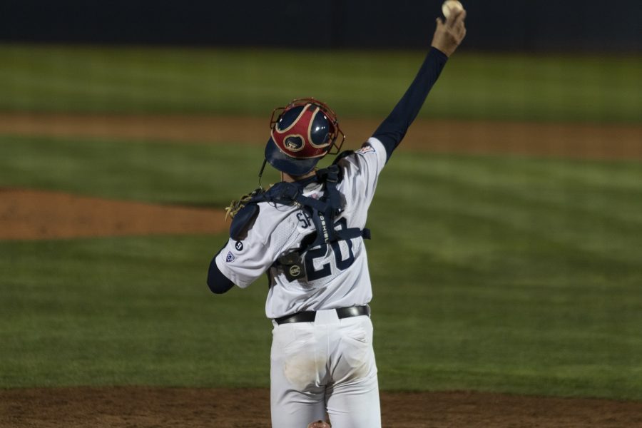 Arizona baseball catcher Tommy Splaine throws a ball back to the pitcher in the game against Utah Tech University on March 21 at Hi Corbett Field. The Arizona baseball team went on to win the game 11-2.