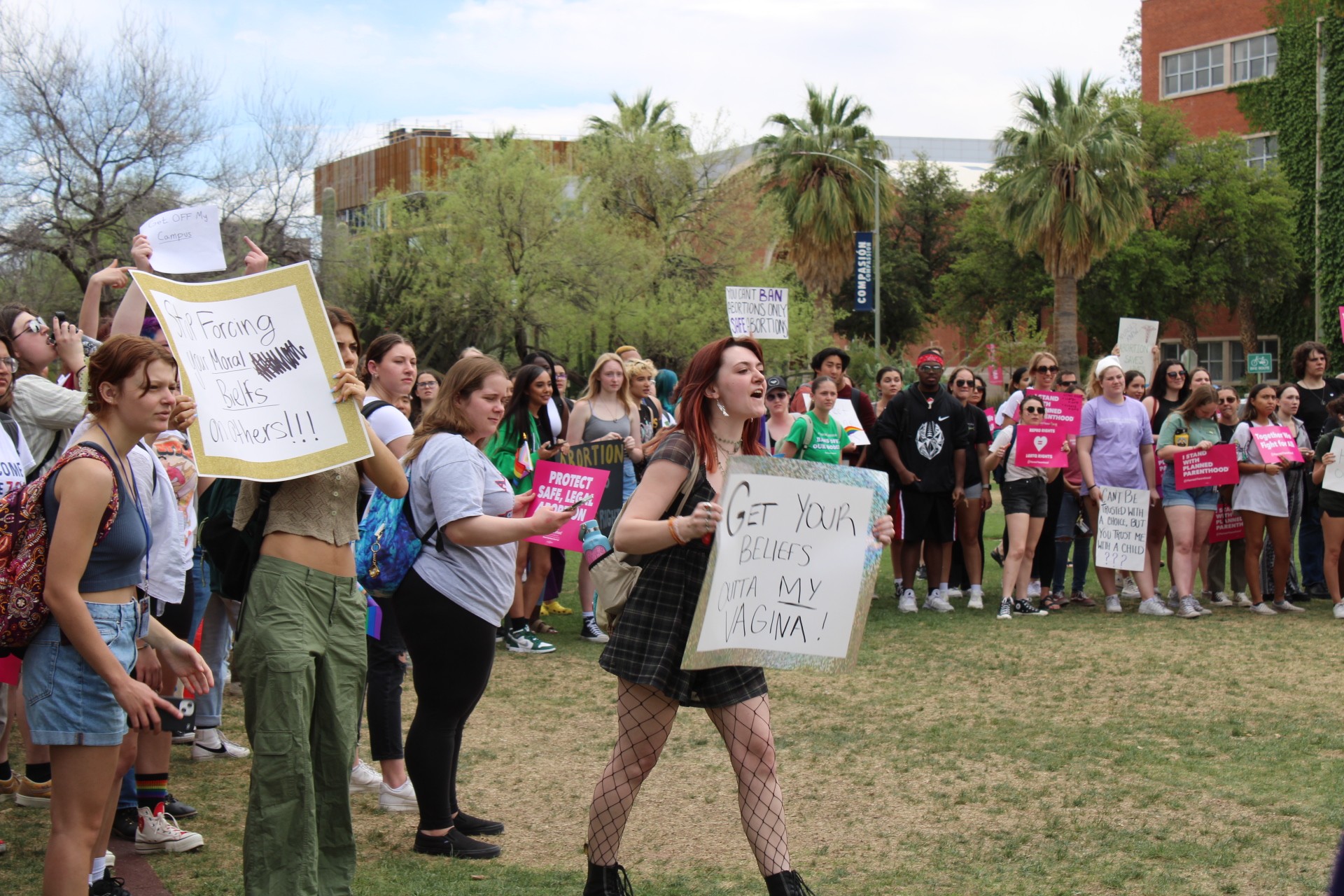 A University of Arizona student and pro-choice supporter shouts and holds a sign that reads "get your beliefs outta my vagina!" amongst a crowd of other protesters Thursday, April 13. This protest was sparked after an anti-abortion group set up a demonstration on the UA Mall displaying large, graphic images depicting blood and dead people for two consecutive days.