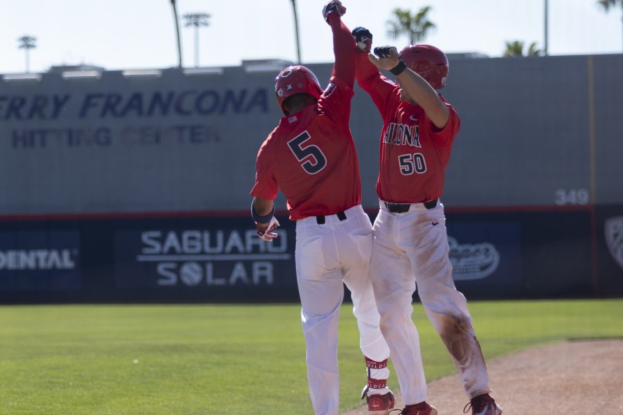 Arizona baseball player Chase Davis (left) celebrates with his teammate Cameron LaLiberte (right) after hitting a home run during the game against the University of Oregon on April 2 in Hi Corbett Field. The Arizona baseball team went on to lose the game with a score of 5-8.
