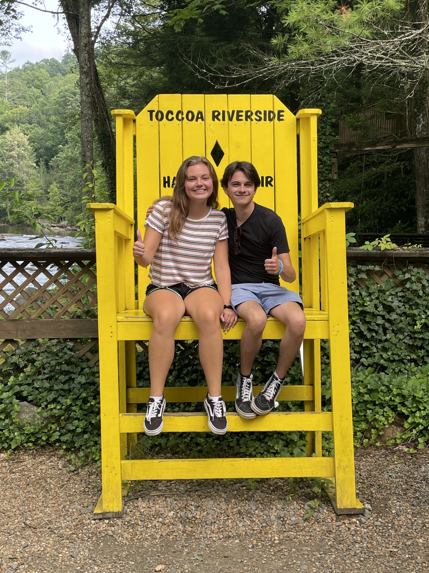 Photo of Meredith Crabtree and Daniel Wittenberg sitting on a yellow chair at Toccoa Riverside Restaurant while Wittenberg was visiting Crabtree's family in Blue Ridge, Georgia, on Thursday, July 21, 2022. The couple emphasizes the importance of self-care in their relationship. (Photo courtesy of Daniel Wittenberg.)